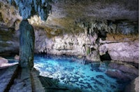 a blue pool inside a cave