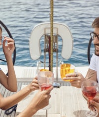 a group of people drinking wine on a boat