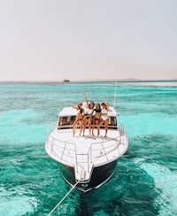 a group of women on a boat in the ocean