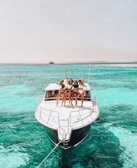 a group of women on a boat in the ocean